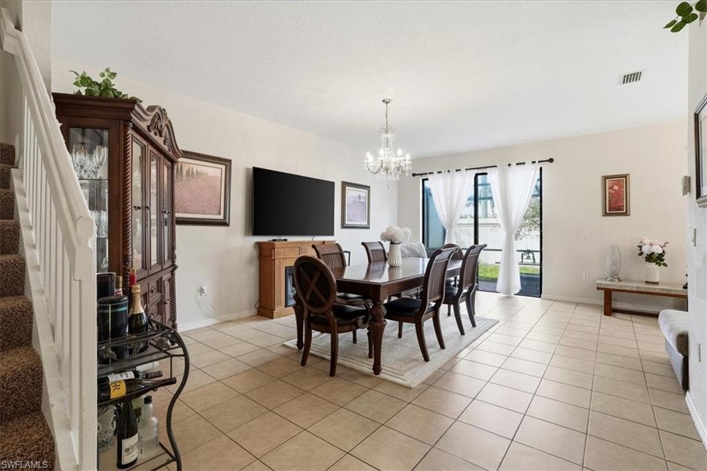 Dining area featuring hanging lights and light tile patterned floors