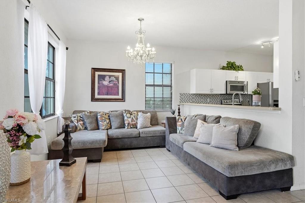 Living room with hanging lights and light tile patterned floors