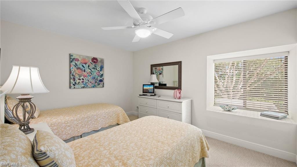 Bedroom with light colored carpet and ceiling fan