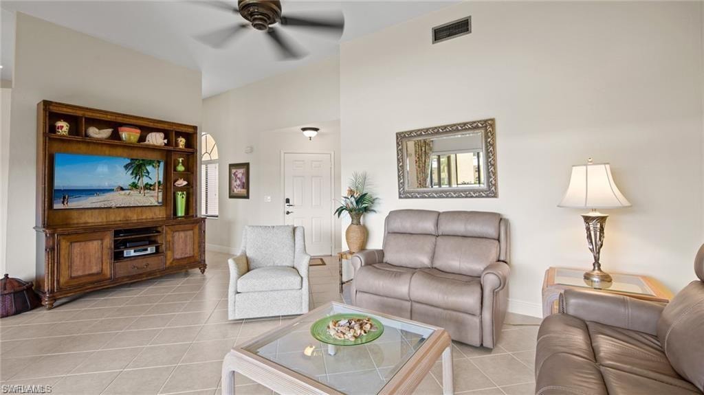 Living area featuring a ceiling fan and light tile patterned floors
