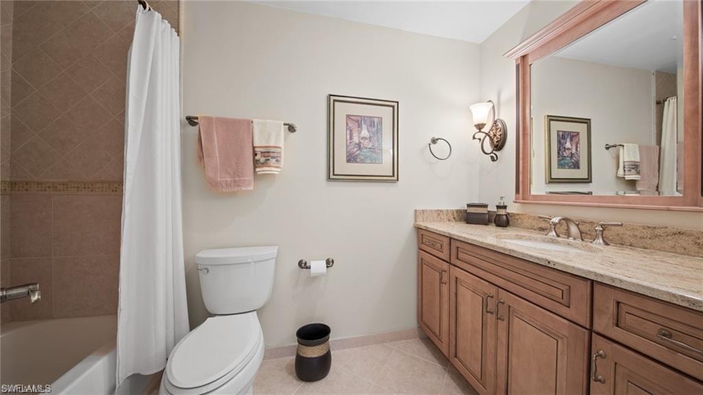 Bathroom with vanity, light tile patterned flooring, and shower / bathtub combination with curtain