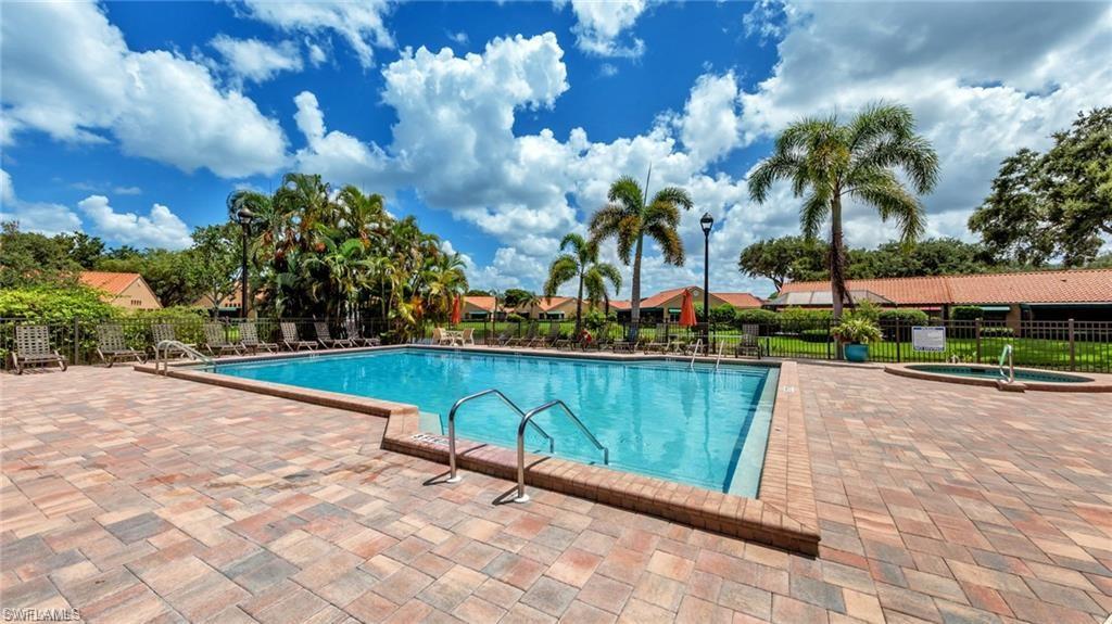 Community pool featuring a patio and a hot tub