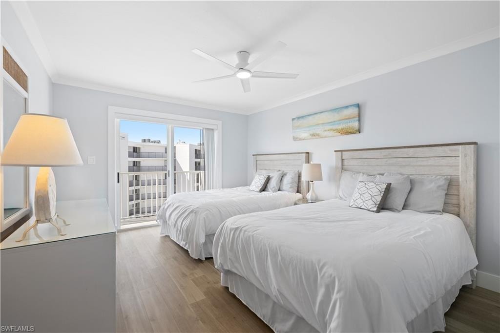 Bedroom with access to exterior, ornamental molding, wood finished floors, and a ceiling fan