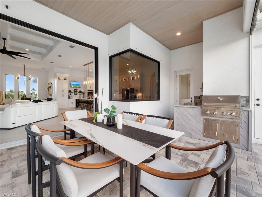 Dining space with suspended lighting, a ceiling fan, and wooden ceiling