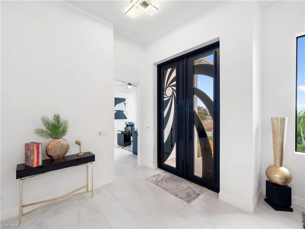Foyer entrance featuring light marble finish flooring and plenty of natural light