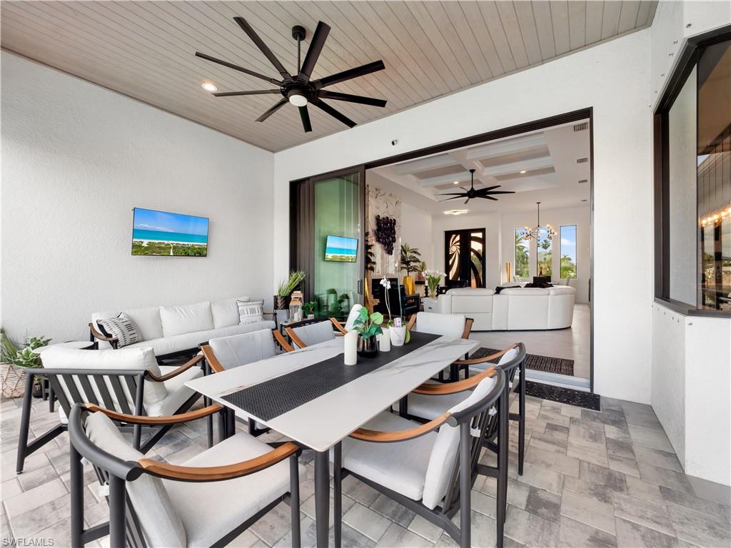 Dining space featuring ceiling fan, wooden ceiling, suspended lighting, and coffered ceiling