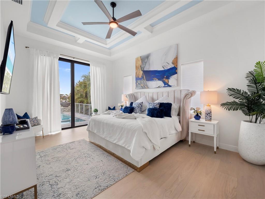 Bedroom featuring access to exterior, light wood finished floors, ornamental molding, and a ceiling fan