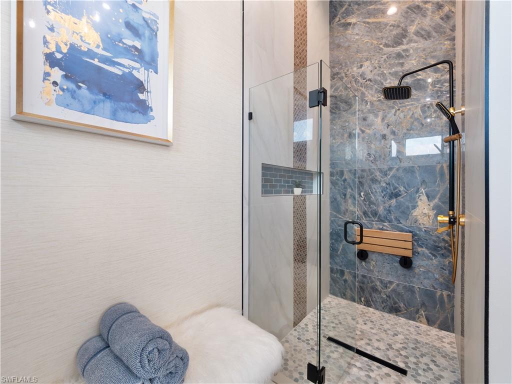 Bathroom with a marble finish shower