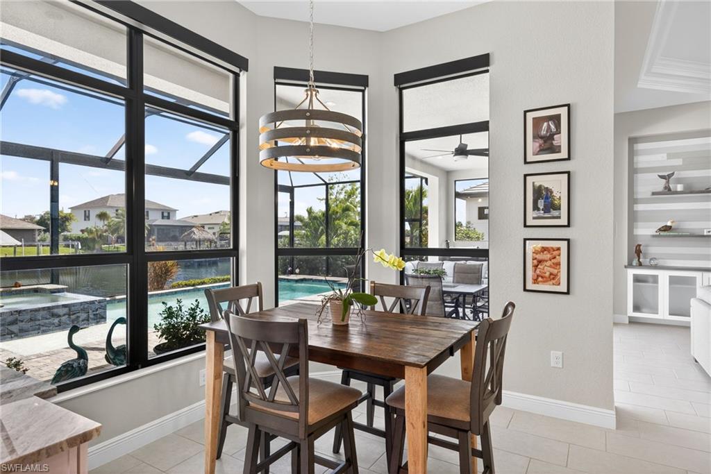 Dining space featuring wine bar and wine cooler, and overlooking the pool and canal