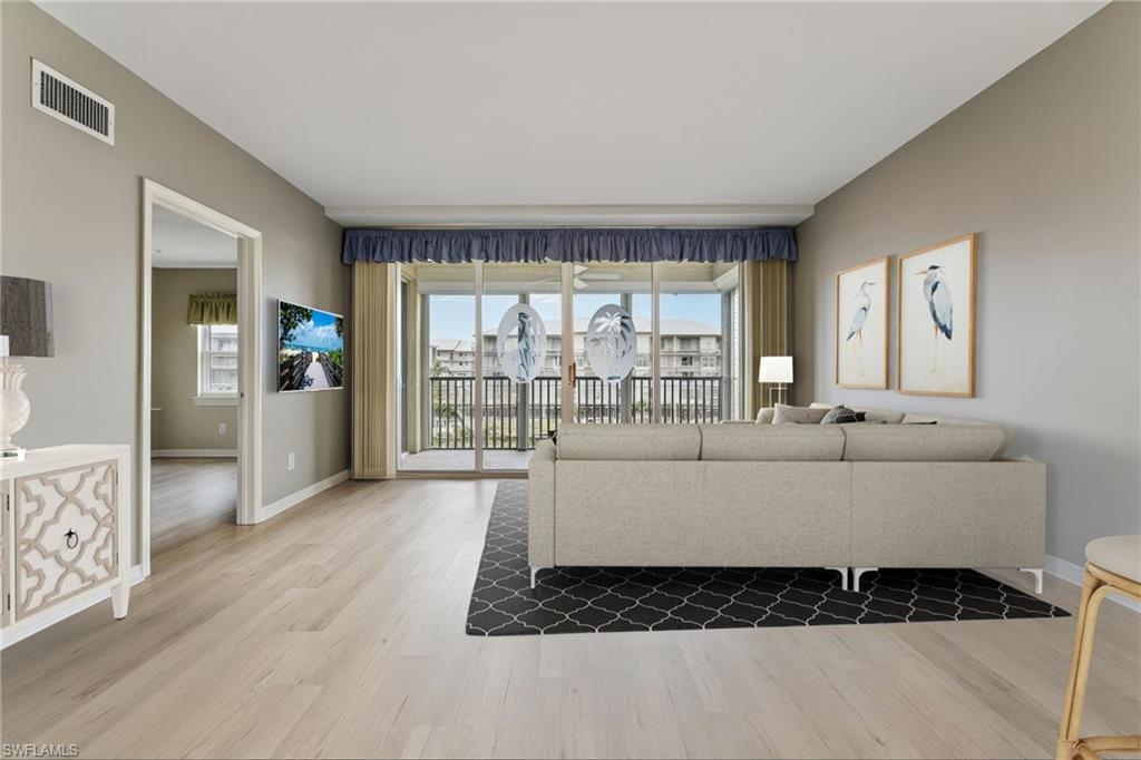 Living area with light wood-style flooring and plenty of natural light