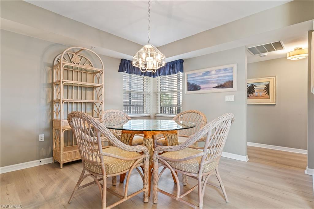 Dining area featuring hanging lights and light wood finished floors