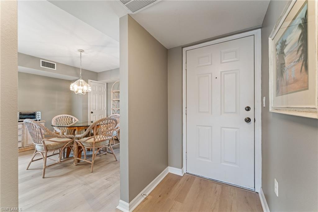 Entrance foyer featuring light wood-style flooring and a chandelier