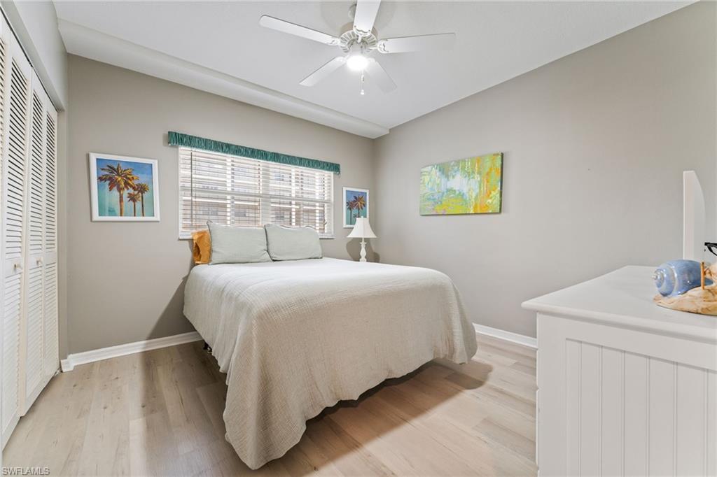 Bedroom featuring a closet, light wood finished floors, and a ceiling fan