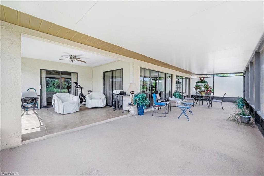 Sunroom featuring ceiling fan and outdoor dining space