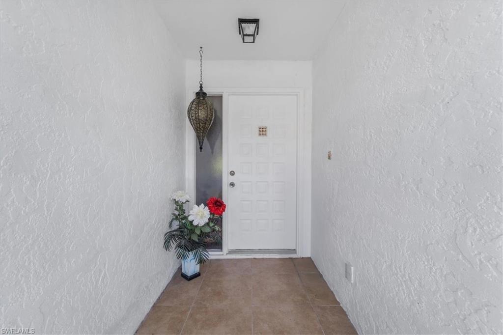 Doorway to property with stucco siding