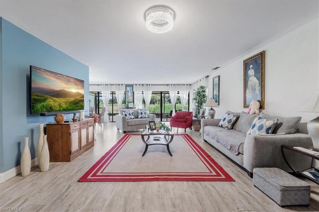 Living area with light wood finished floors and baseboards
