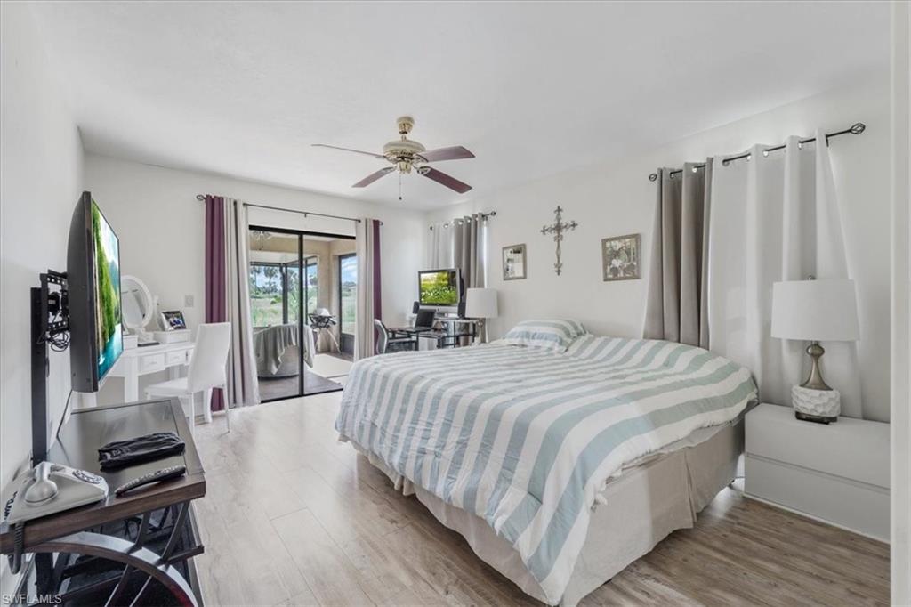 Bedroom featuring light wood-style floors, access to outside, and ceiling fan