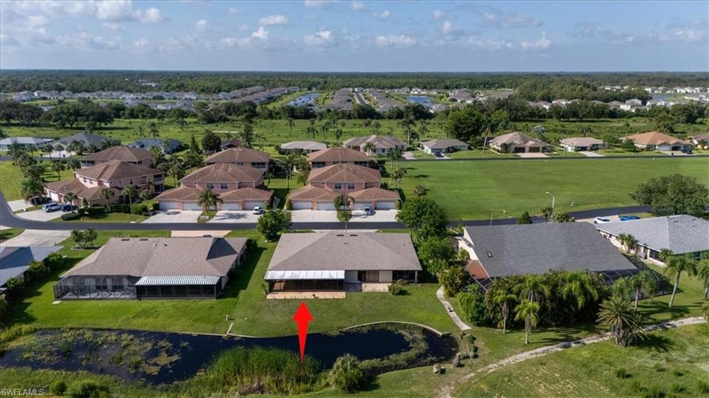 Aerial perspective of suburban area with a nearby body of water