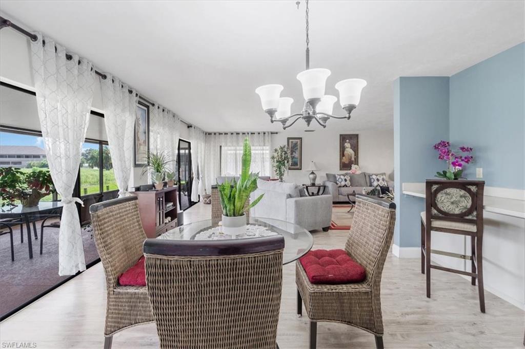 Dining space with hanging lights and light wood finished floors