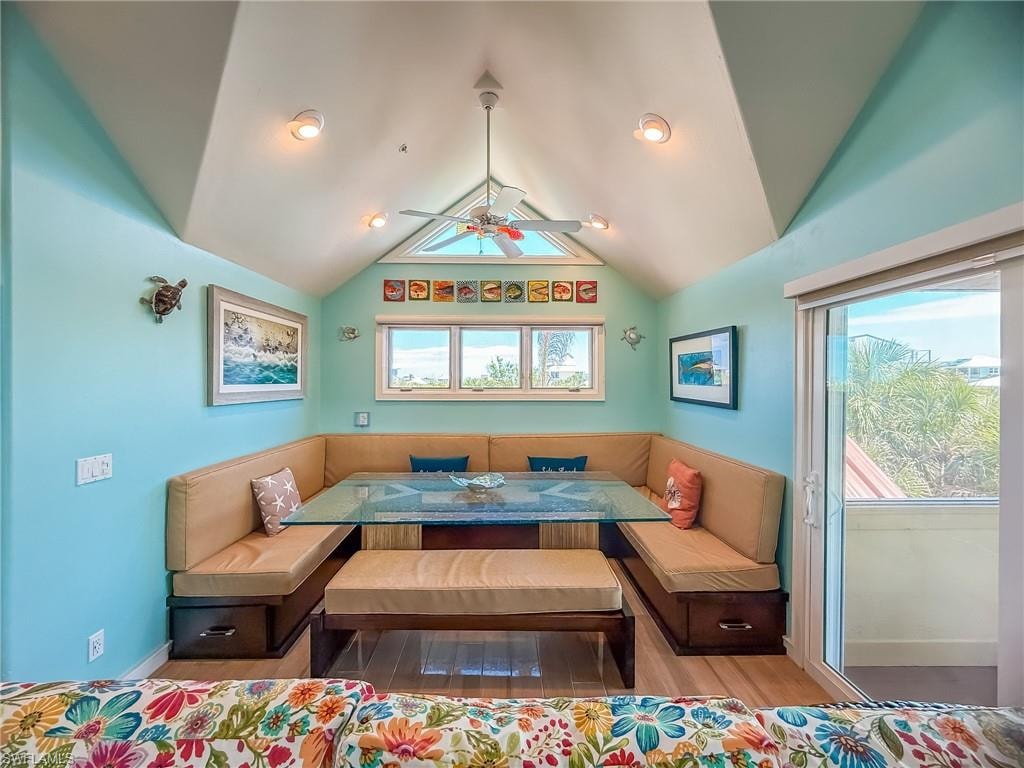 Living area with vaulted ceiling with beams and a ceiling fan