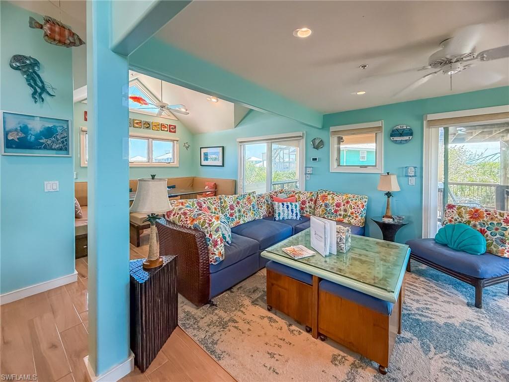 Living room with recessed lighting, ceiling fan, and light wood-style flooring