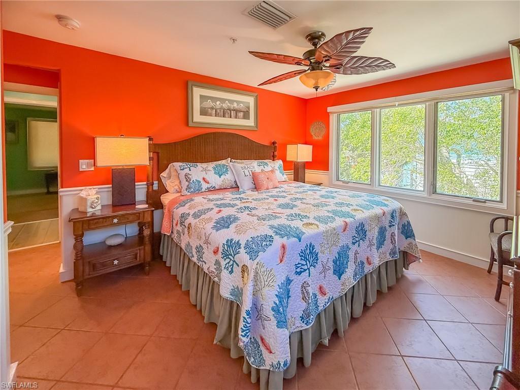 Bedroom with a ceiling fan, visible vents, and light tile patterned floors