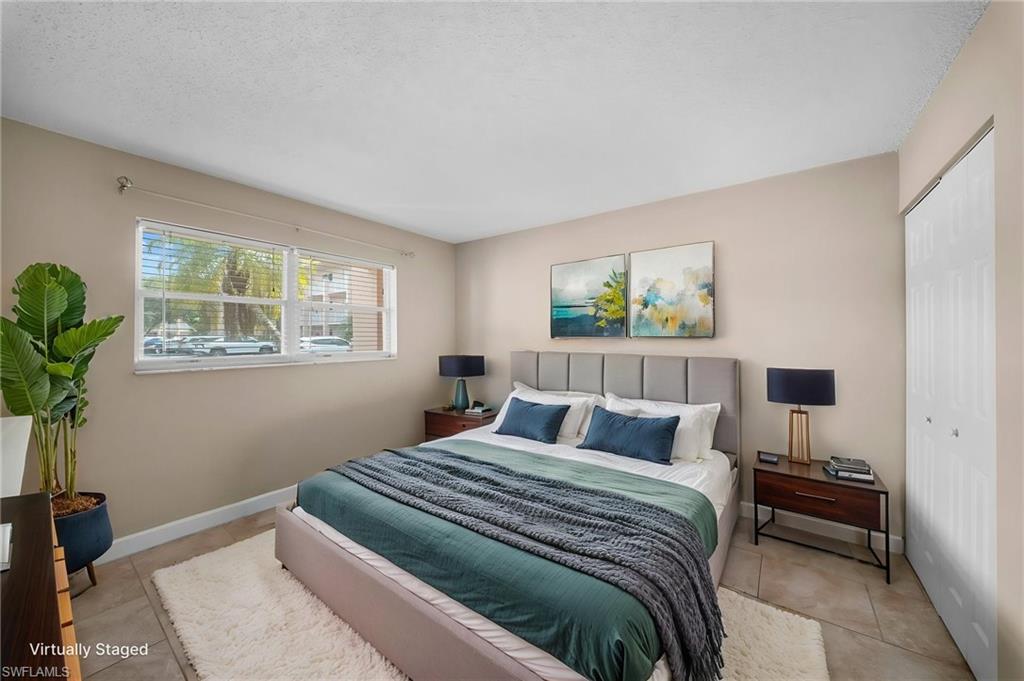 Bedroom with a closet and light tile patterned floors