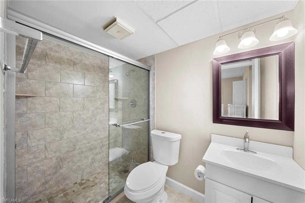 Full bathroom featuring vanity and a shower stall