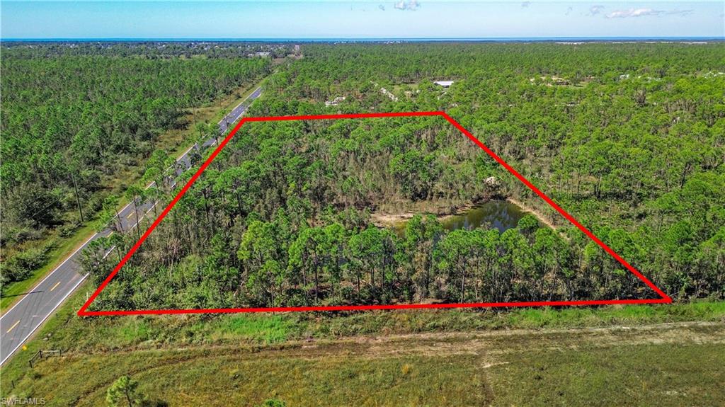 Aerial view of property's location with property boundaries highlighted and a heavily wooded area