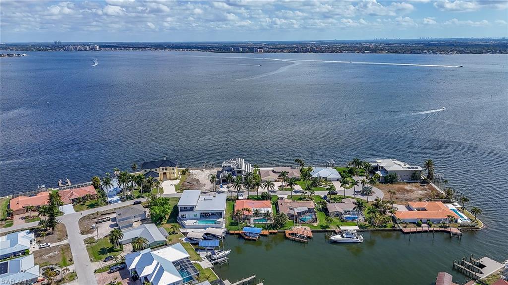 Aerial view of property's location featuring nearby suburban area and a nearby body of water