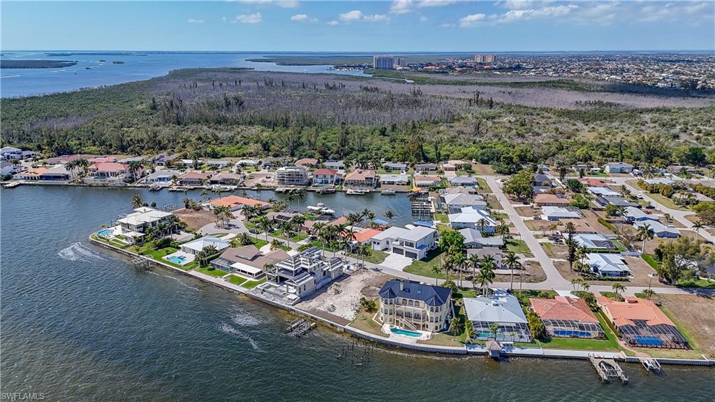 Aerial perspective of suburban area with a nearby body of water