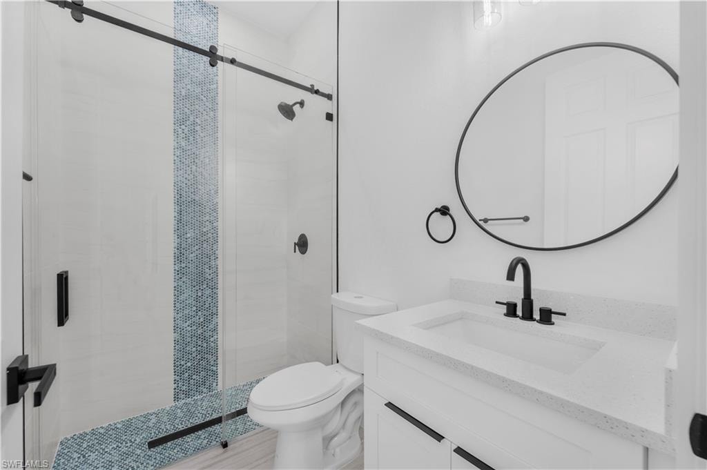 Full bath room  featuring a stall shower and vanity