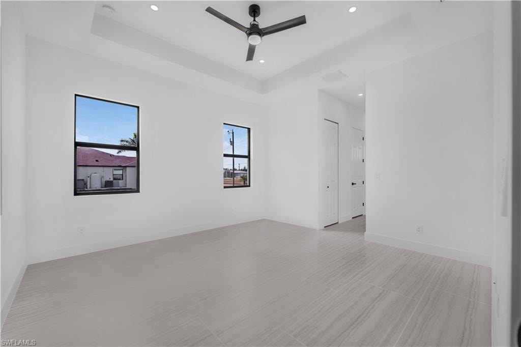 Unfurnished Masterroom featuring a raised ceiling, ceiling fan, and recessed lighting