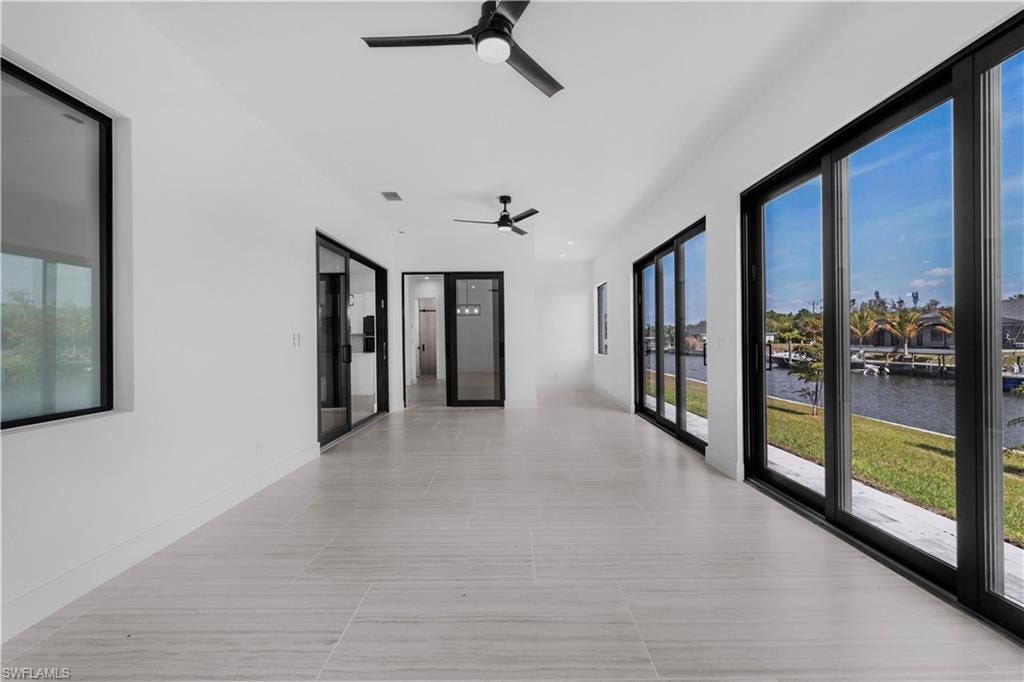 Corridor with a water view and baseboards