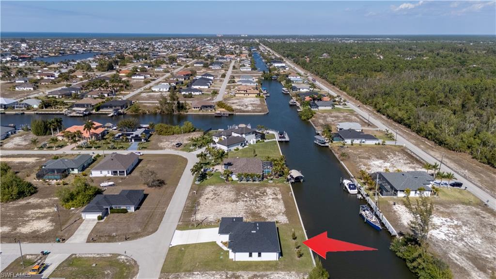 Aerial view of property's location featuring nearby suburban area
