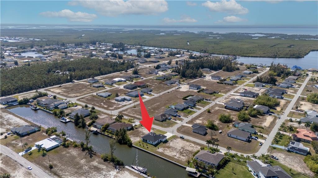 View of property location featuring a large body of water and nearby suburban area
