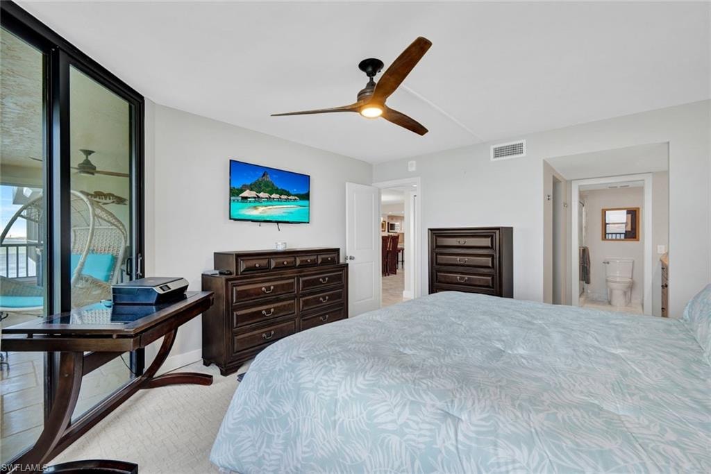 Bedroom with access to outside, a ceiling fan, and ensuite bath