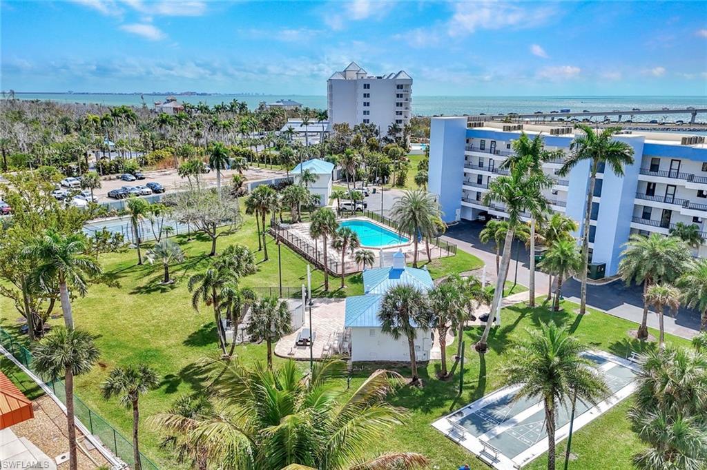 Drone / aerial view of a nearby body of water and apartment complex / building