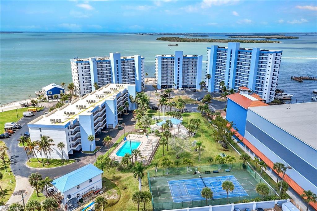 Drone / aerial view of apartment complex and a large body of water