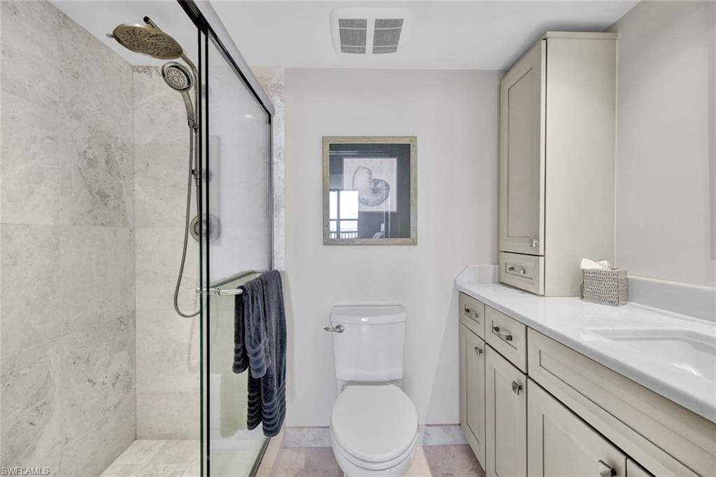 Full bath with a shower stall and vanity