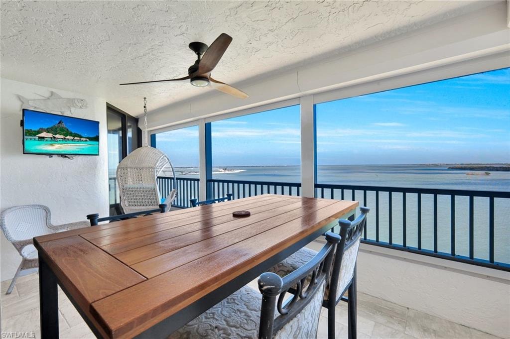 Sunroom / solarium featuring a water view