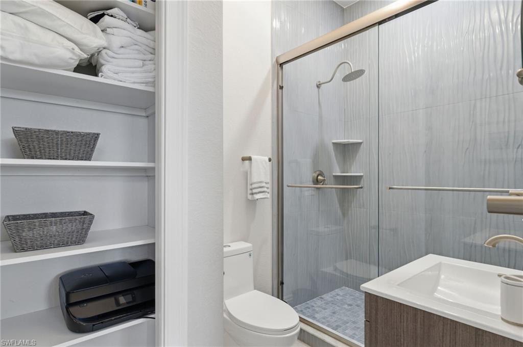 Bathroom featuring vanity and a shower stall