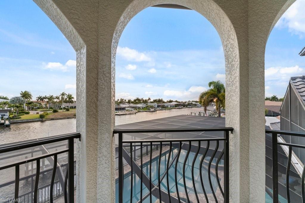 Balcony with a residential view and a water view