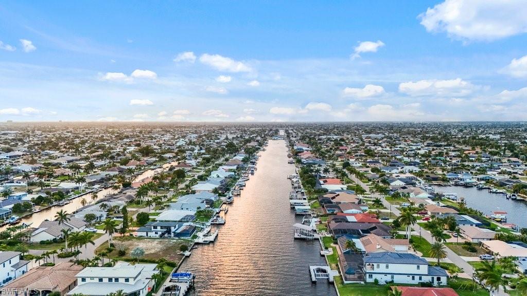 Aerial view of residential area featuring a nearby body of water
