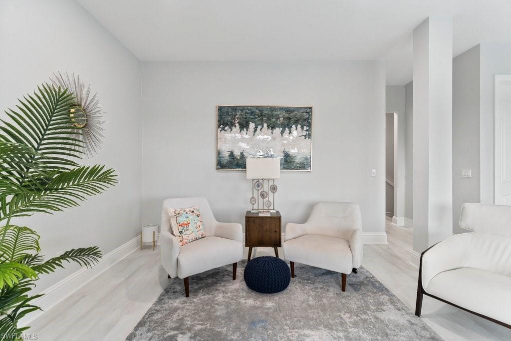 Living area with wood finished floors and baseboards