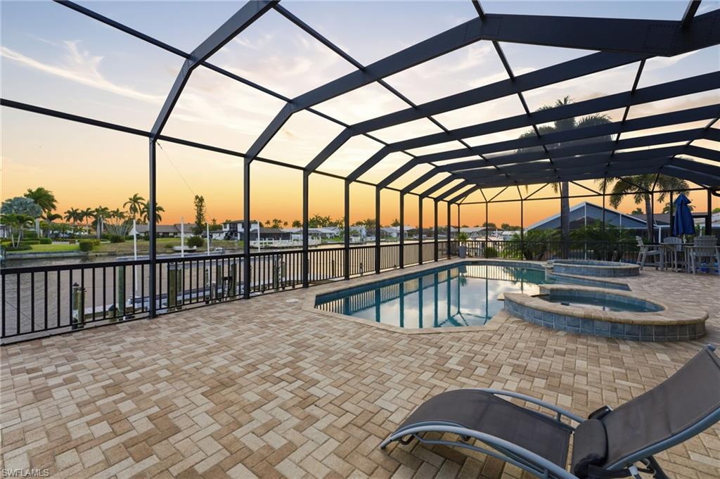 Integrated pool / spa featuring a patio area, glass enclosure, and a sunroom