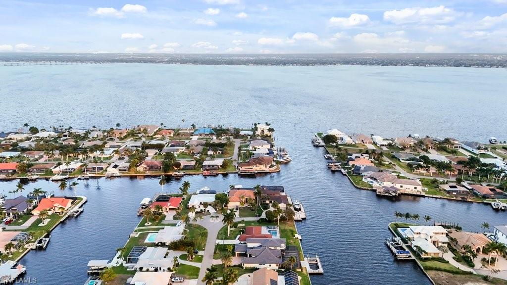 Aerial view of residential area featuring a nearby body of water