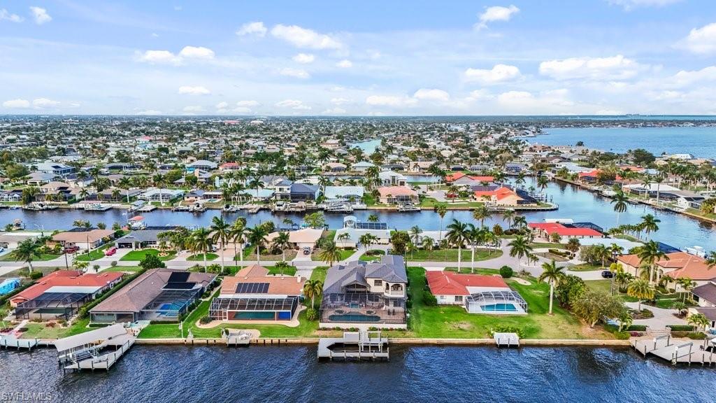 Aerial perspective of suburban area featuring a large body of water