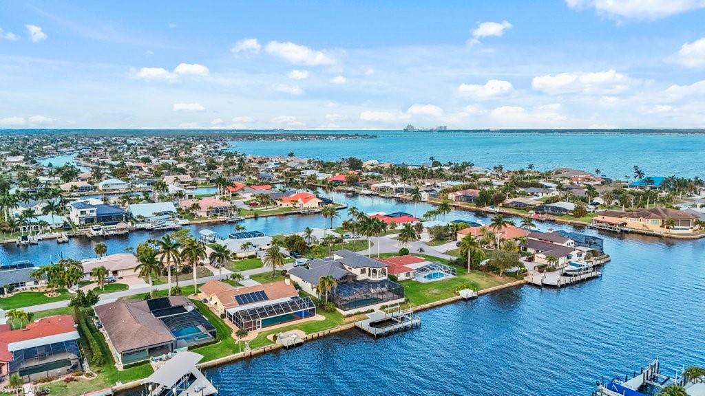 Aerial perspective of suburban area featuring a large body of water