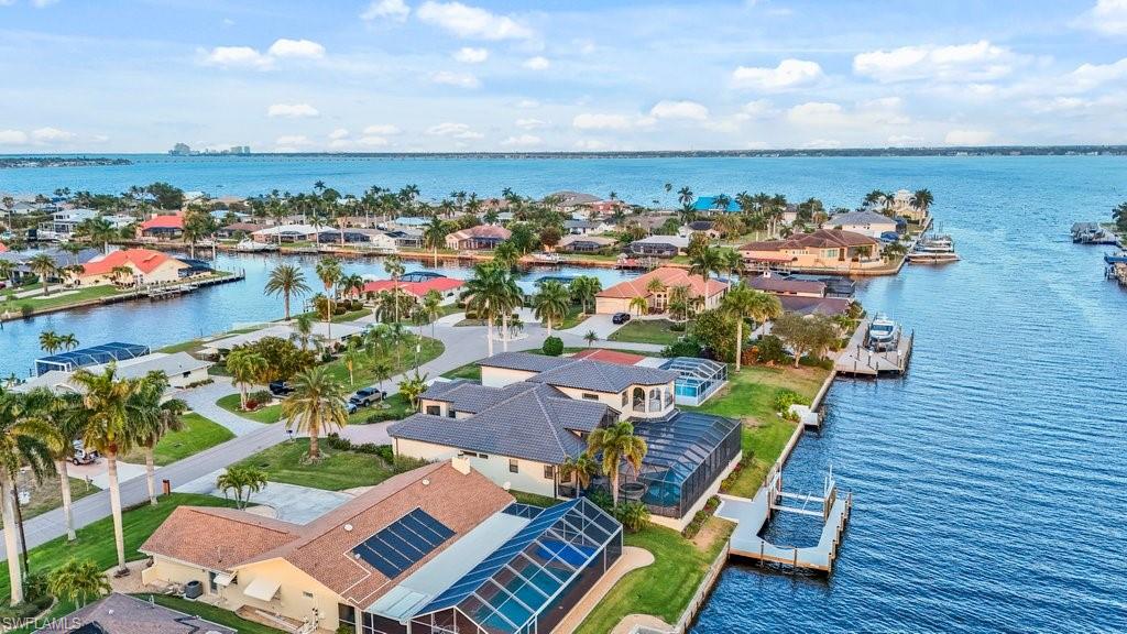 Aerial view of residential area featuring a nearby body of water